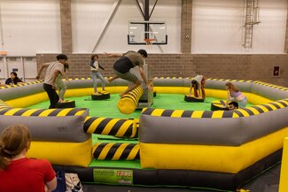 students jumping on inflatable